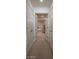 Long hallway providing ample closet space with doors spanning both sides at 2515 S Atlantic Ave # 203, Daytona Beach, FL 32118