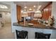 Bright kitchen with granite counters, bar seating, and pendant lighting at 2515 S Atlantic Ave # 203, Daytona Beach, FL 32118