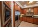 Updated kitchen with stainless appliances, granite countertops, and wood cabinets at 2515 S Atlantic Ave # 203, Daytona Beach, FL 32118