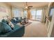 Bright living room featuring ocean view, comfortable seating, and ceiling fan at 2515 S Atlantic Ave # 203, Daytona Beach, FL 32118