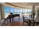 Bright living room with hardwood floors, piano, and panoramic ocean views at 2515 S Atlantic Ave # 203, Daytona Beach, FL 32118