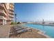 Large oceanfront pool with sundeck featuring chaise lounges and umbrellas at 2515 S Atlantic Ave # 203, Daytona Beach, FL 32118