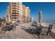 Pool deck area featuring lounging area with patio tables and umbrellas at 2515 S Atlantic Ave # 203, Daytona Beach, FL 32118