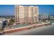 Aerial shot of condo and large swimming pool on sandy beach at 2515 S Atlantic Ave # 203, Daytona Beach, FL 32118