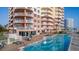 Exterior shot showcasing a large pool and deck with patio furniture and ocean views at 2515 S Atlantic Ave # 203, Daytona Beach, FL 32118