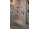 Walk-in shower featuring tile surround, bench, and glass enclosure at 2515 S Atlantic Ave # 203, Daytona Beach, FL 32118