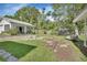 Large backyard with lush greenery and a covered patio at 2676 Palm Terrace St, Deland, FL 32720