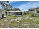 View of the home's backyard, featuring a screened-in porch and open outdoor space at 2676 Palm Terrace St, Deland, FL 32720