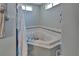 Relaxing bathroom with a corner jacuzzi tub and tile accents, creating a spa-like atmosphere at 2676 Palm Terrace St, Deland, FL 32720