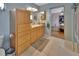 Functional bathroom with wooden cabinets, ample storage, and a view into the primary bedroom at 2676 Palm Terrace St, Deland, FL 32720