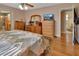 Spacious bedroom featuring hardwood floors, wooden furniture, and access to an en-suite bathroom at 2676 Palm Terrace St, Deland, FL 32720