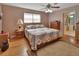 Comfortable bedroom with hardwood floors, a ceiling fan, and natural light from a window at 2676 Palm Terrace St, Deland, FL 32720