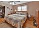 Cozy bedroom with a decorative quilt on the bed, a ceiling fan, and natural light from the window at 2676 Palm Terrace St, Deland, FL 32720