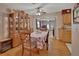 Bright dining area with hardwood floors, a china cabinet, and views of the living room at 2676 Palm Terrace St, Deland, FL 32720