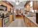 Bright kitchen with wooden cabinets and stainless steel appliances, leading into a dining area at 2676 Palm Terrace St, Deland, FL 32720