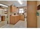 Well-lit kitchen featuring warm wood cabinetry and tile floors at 2676 Palm Terrace St, Deland, FL 32720