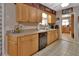 Charming kitchen featuring wooden cabinetry, and a view to an adjacent room through an open doorway at 2676 Palm Terrace St, Deland, FL 32720