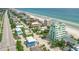 Breathtaking aerial view of a coastal community with stunning beachfront properties and a charming, vibrant condo building at 2801 Hill St # 801, New Smyrna Beach, FL 32169