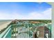 Balcony with teal railings overlooking the coastal town, with beautiful homes and scenic ocean view at 2801 Hill St # 801, New Smyrna Beach, FL 32169