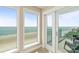 Balcony with tile flooring offering scenic ocean views from expansive windows and a glass door at 2801 Hill St # 801, New Smyrna Beach, FL 32169