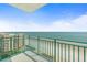 Expansive view of the beach from the condo balcony, featuring a blue railing and coastal scenery at 2801 Hill St # 801, New Smyrna Beach, FL 32169