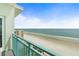 Enjoy calming beach views from this condo's private balcony with an aqua railing, perfect for relaxing and enjoying coastal scenery at 2801 Hill St # 801, New Smyrna Beach, FL 32169