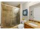Bathroom features a tiled shower, granite countertop, and coastal-themed decor at 2801 Hill St # 801, New Smyrna Beach, FL 32169