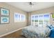 This bedroom features neutral walls, carpet floors, plantation shutters, and a ceiling fan at 2801 Hill St # 801, New Smyrna Beach, FL 32169