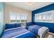 Bright bedroom with two twin beds, shuttered windows offering serene neighborhood views at 2801 Hill St # 801, New Smyrna Beach, FL 32169