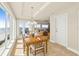 Bright dining room featuring a chandelier, wood table set, and panoramic ocean views from large windows at 2801 Hill St # 801, New Smyrna Beach, FL 32169