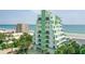 Stunning oceanfront condo with private balconies and vibrant green accents offers breathtaking coastal views at 2801 Hill St # 801, New Smyrna Beach, FL 32169