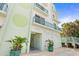 Inviting entrance with lush landscaping and decorative planters, showcasing the stylish design of this coastal condominium at 2801 Hill St # 801, New Smyrna Beach, FL 32169