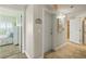 Hallway featuring tile floors, access to bedrooms, laundry closet and exterior door at 2801 Hill St # 801, New Smyrna Beach, FL 32169