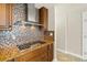 Close up on a Kitchen with modern appliances, including a stove and hood and nice backsplash at 2801 Hill St # 801, New Smyrna Beach, FL 32169