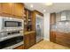 Modern kitchen with stainless steel appliances, wooden cabinets, granite countertops and tiled backsplash at 2801 Hill St # 801, New Smyrna Beach, FL 32169