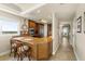 Modern kitchen featuring granite countertops, breakfast bar, stainless steel appliances and mosaic backsplash at 2801 Hill St # 801, New Smyrna Beach, FL 32169