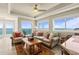 Comfortable living room featuring tile floors, tray ceiling, large windows with ocean views, and modern decor at 2801 Hill St # 801, New Smyrna Beach, FL 32169