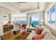 Spacious living room featuring views to the dining room and floor to ceiling windows overlooking the ocean at 2801 Hill St # 801, New Smyrna Beach, FL 32169