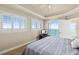 This spacious bedroom features a tray ceiling, a ceiling fan, plantation shutters, and balcony access at 2801 Hill St # 801, New Smyrna Beach, FL 32169