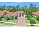 Beautiful house with mature landscaping, barrel tile roof, paver driveway, and lush landscaping at 2825 S Asciano Ct, New Smyrna Beach, FL 32168