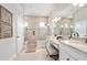 Elegant bathroom featuring double sink vanity, glass shower, and neutral tile flooring at 2825 S Asciano Ct, New Smyrna Beach, FL 32168