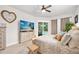 Comfortable bedroom with a ceiling fan, decorative wall art, and sliding door access to the outdoor area at 2825 S Asciano Ct, New Smyrna Beach, FL 32168