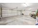 Spacious two car garage with overhead lighting and electrical door openers, featuring a golf cart at 2825 S Asciano Ct, New Smyrna Beach, FL 32168