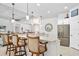 Open kitchen with granite countertop, stainless fridge, and breakfast bar at 2825 S Asciano Ct, New Smyrna Beach, FL 32168