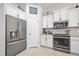 Bright kitchen featuring stainless steel appliances and white cabinetry for a clean, modern look at 2825 S Asciano Ct, New Smyrna Beach, FL 32168