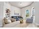 Comfortable living area featuring tile floors, a tray ceiling, and an oversized arched window at 2825 S Asciano Ct, New Smyrna Beach, FL 32168