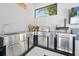 Fully equipped stainless steel outdoor kitchen with grill, sink, and countertops for alfresco dining at 2825 S Asciano Ct, New Smyrna Beach, FL 32168