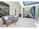 Cozy outdoor area with comfortable seating, an outdoor kitchen, and view to indoor entertainment area at 2825 S Asciano Ct, New Smyrna Beach, FL 32168