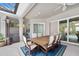 Covered outdoor patio with dining area, hot tub, and view of the pool at 2825 S Asciano Ct, New Smyrna Beach, FL 32168
