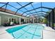 Stunning pool area with a screen enclosure, dining, and lounge spaces for outdoor enjoyment at 2825 S Asciano Ct, New Smyrna Beach, FL 32168